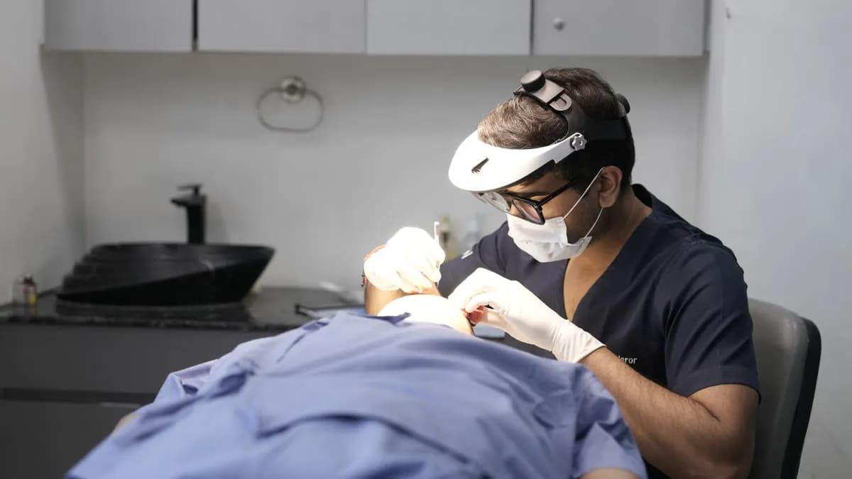 Dermatologist performing scalp assessment in a clinical hair loss consultation