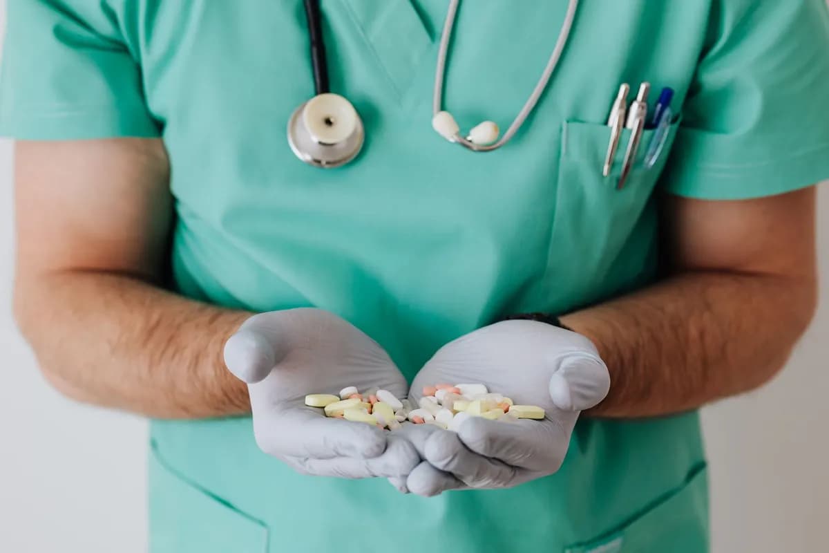 Doctor holding prescription medication — hair-loss medication is a prescription-only medicine in Malta