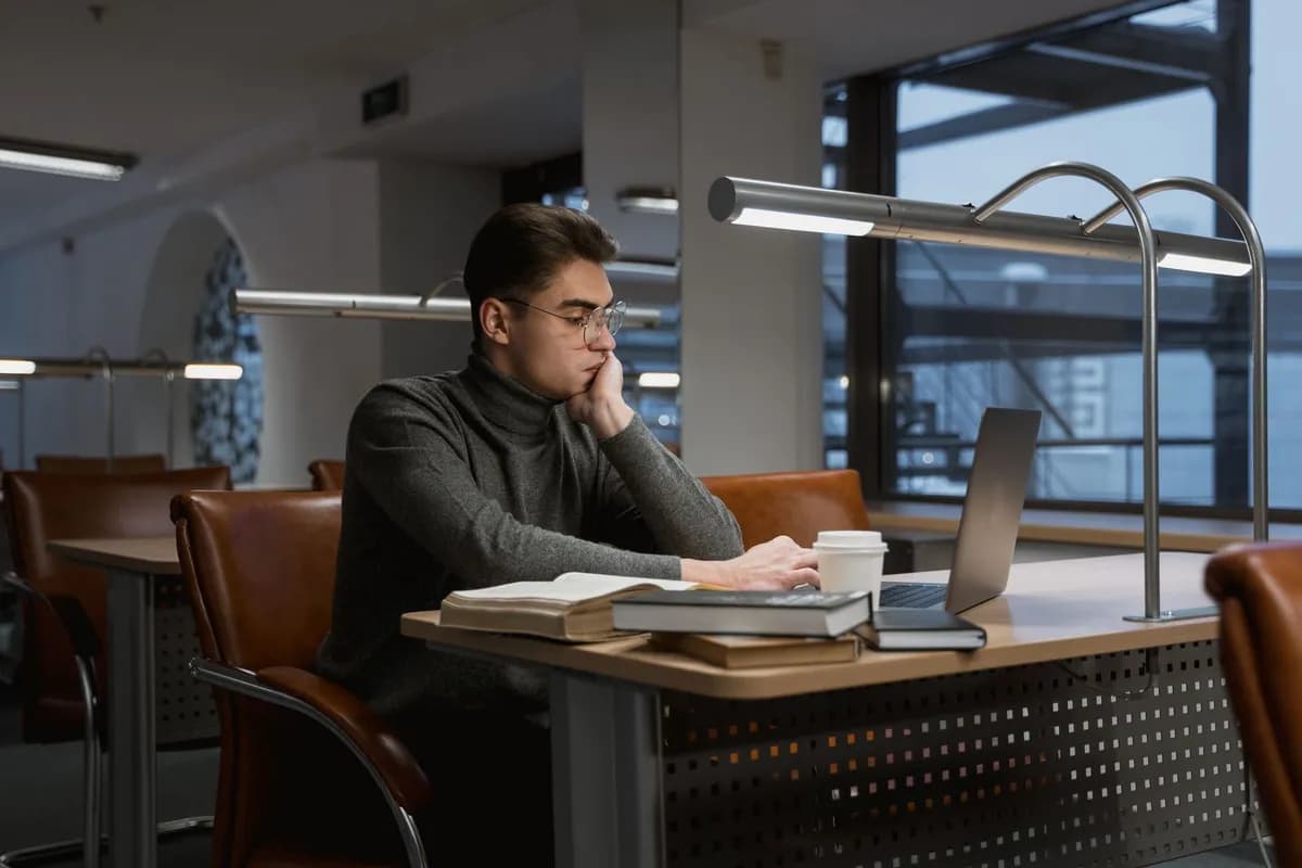 Man researching hair-loss medication side effects on laptop late at night