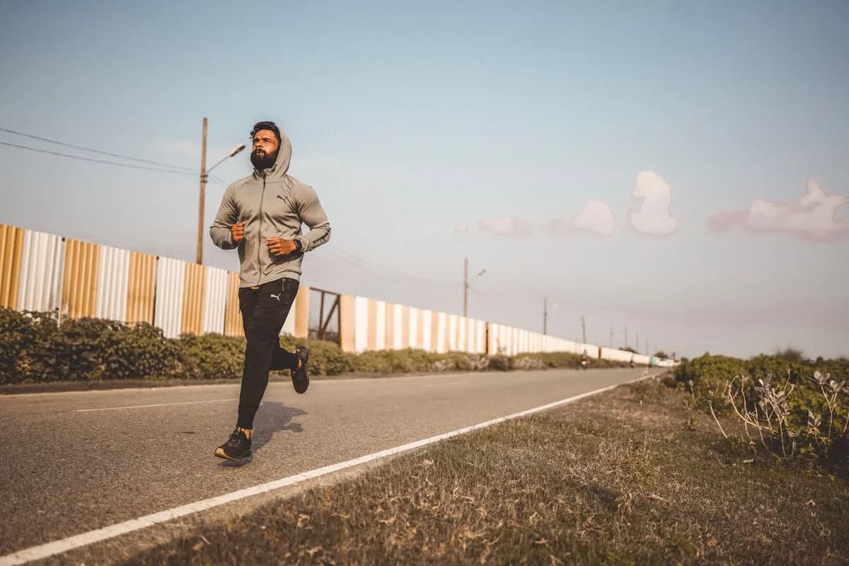 Man running outdoors in sunny conditions — exercise and scalp health benefits