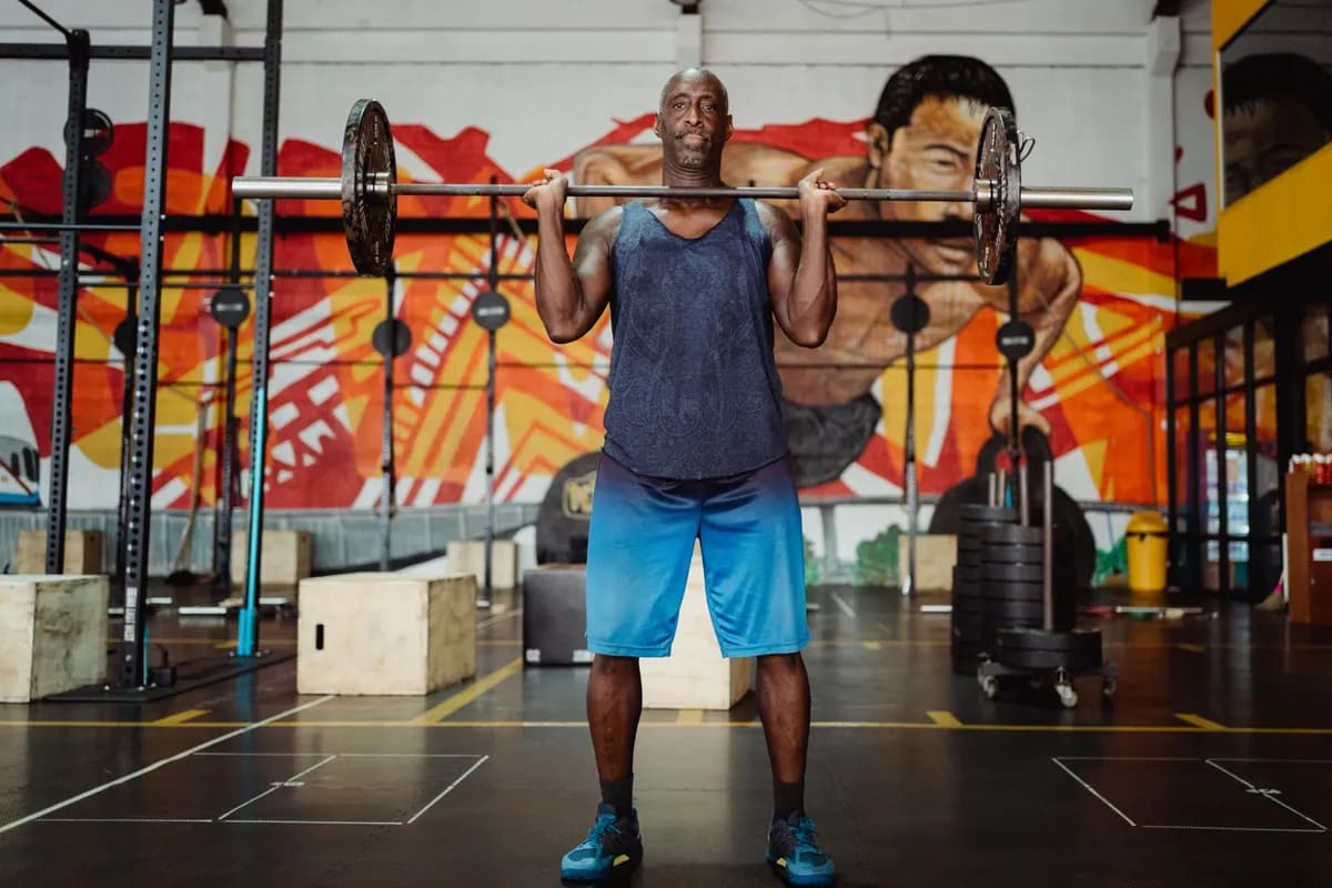 Man performing weight training in gym — DHT and exercise relationship for hair loss