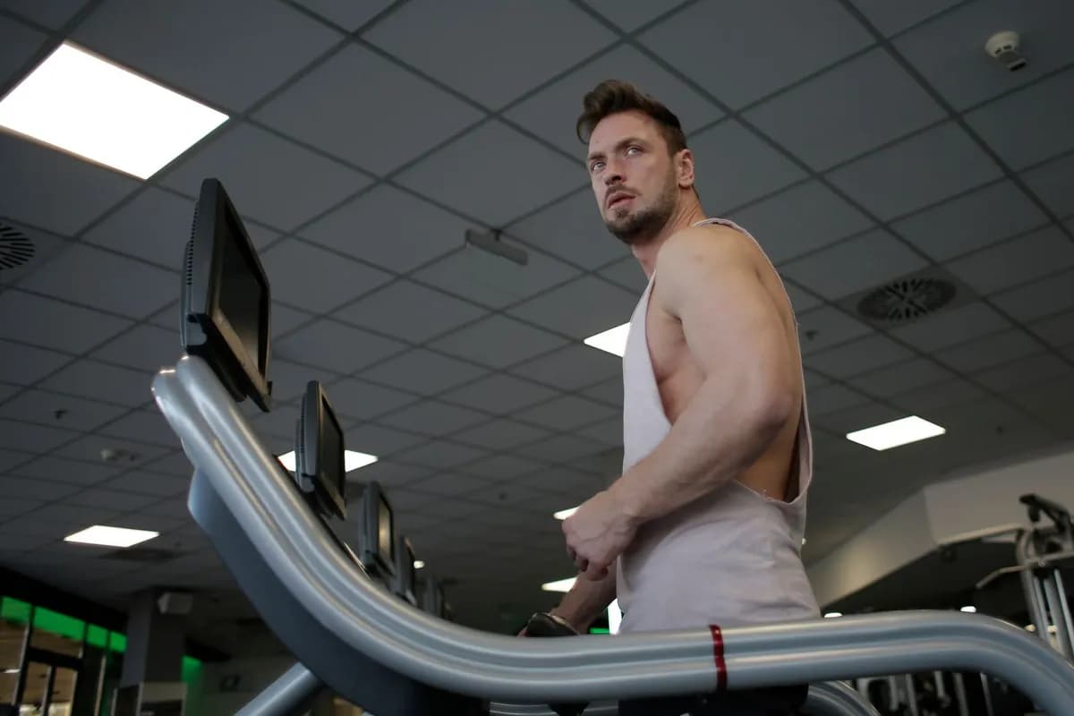 Active man training on treadmill — how to prevent hair loss while training for men in Malta