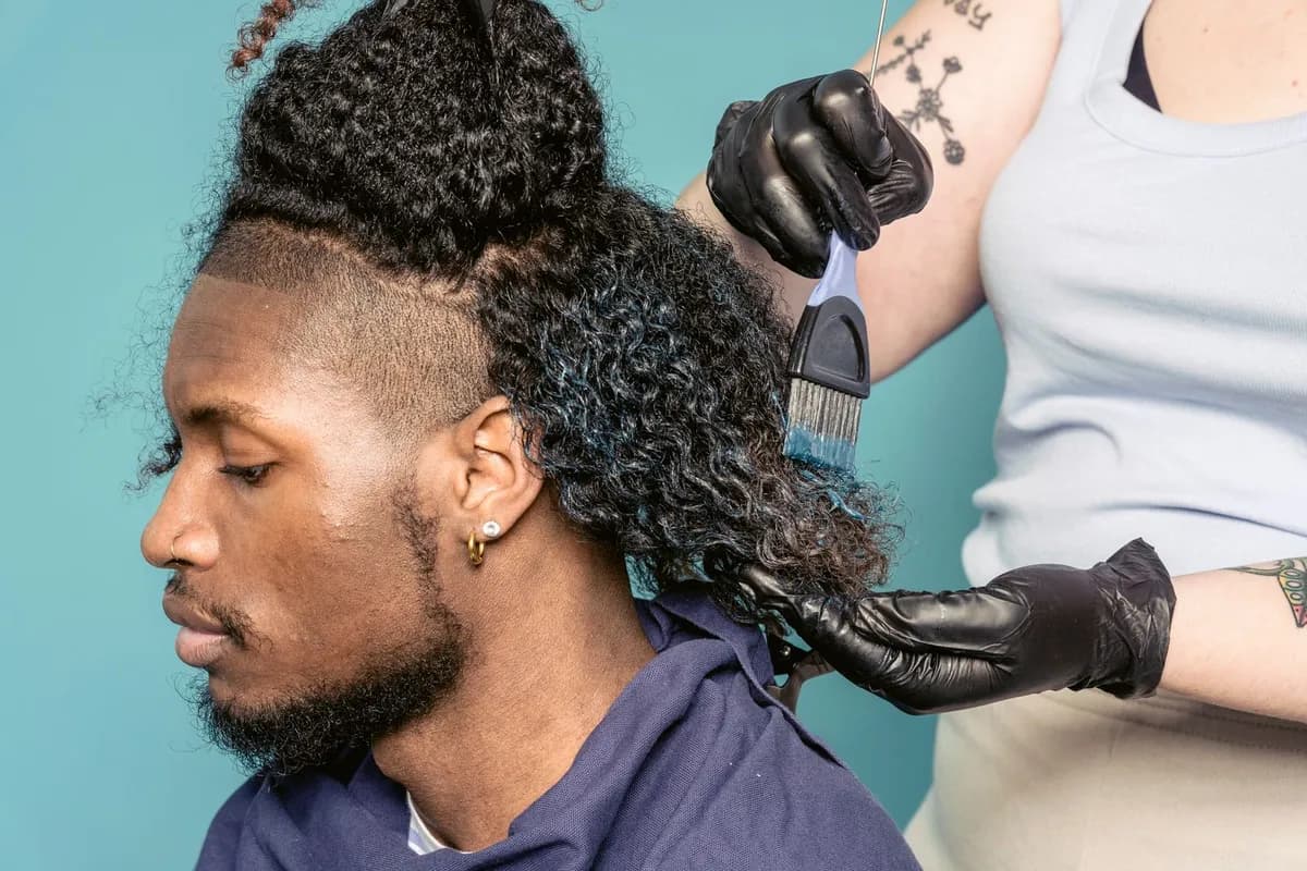 Man receiving topical hair treatment applied by clinician, illustrating topical treatment application for hair loss in Malta