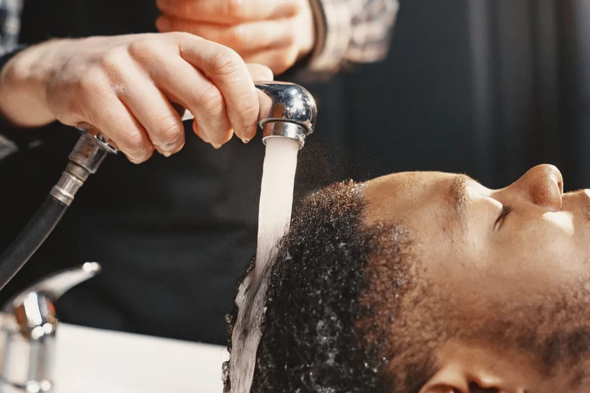 Close-up of a man's scalp and hair during a professional hair assessment consultation