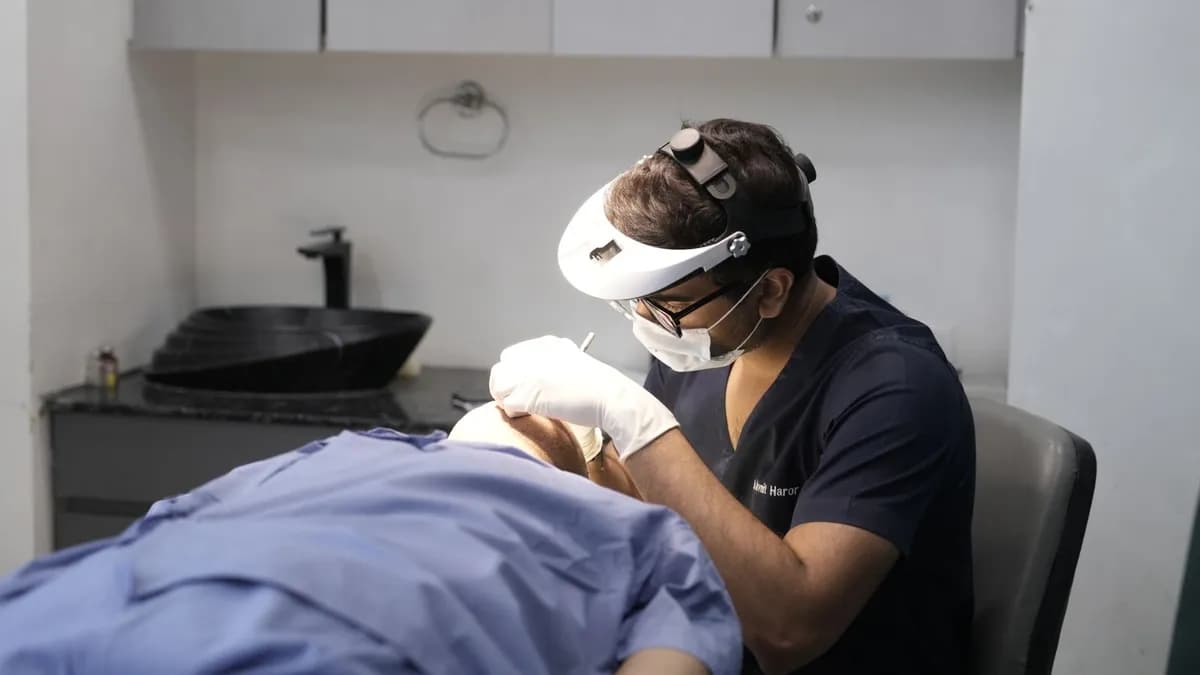 Dermatologist conducting a hair treatment procedure in a clinical setting — receding hairline treatment Malta