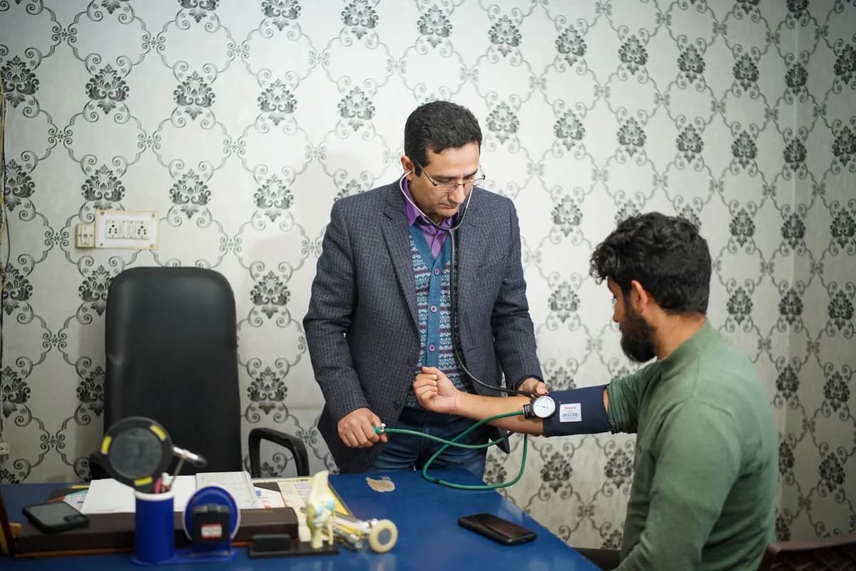 Doctor conducting a medical consultation with a male patient discussing hair loss causes in Malta