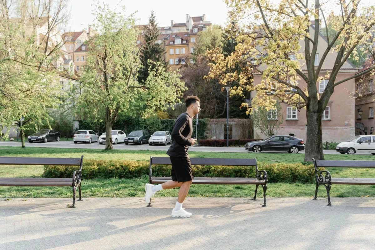 Man jogging outdoors in sunlight — Malta UV exposure is a genuine scalp health consideration for active men training outdoors