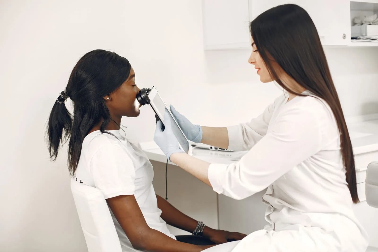 Specialist using advanced imaging equipment during a scalp consultation